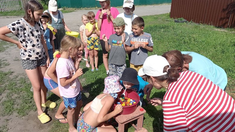 Children participate in games during the summer playground.
