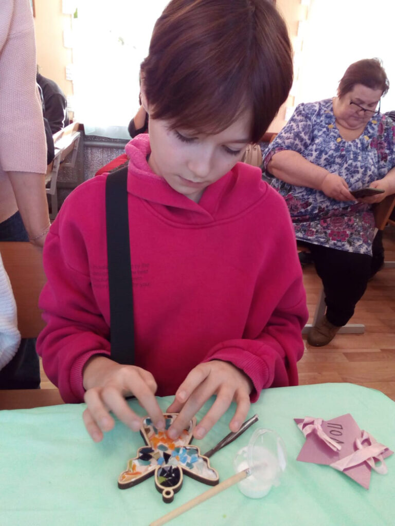 Polina works on a craft.