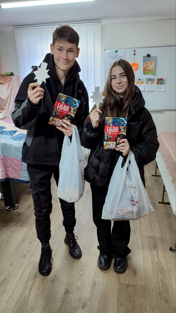 Davyd and Sofia with gifts from the outreach.